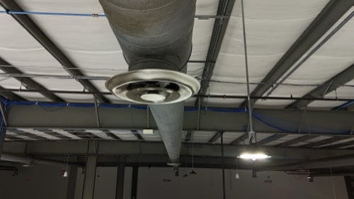 Heavy grime caked on an overhead vent